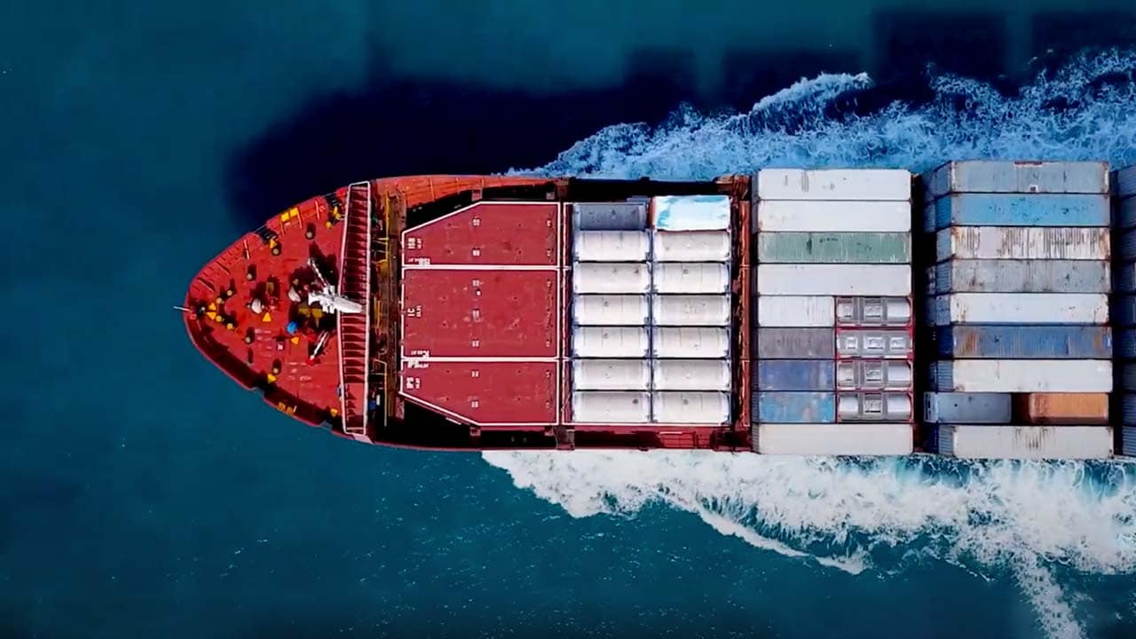 Streamlined US-EU supply chain visualization with cargo ships, stablecoin escrow securing invoices, and digital blockchain ledgers for B2B payments